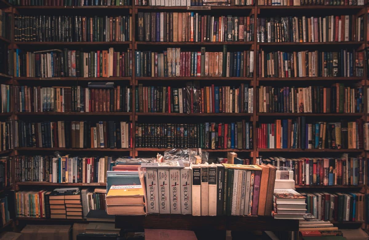 Thousands of books on shelves and a table.