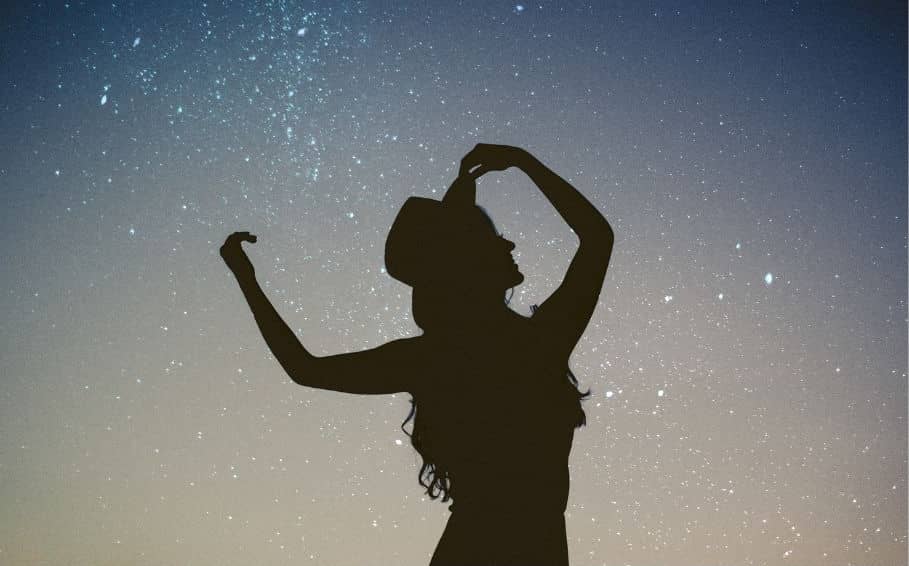 Silhouette of a woman against an evening sky.
