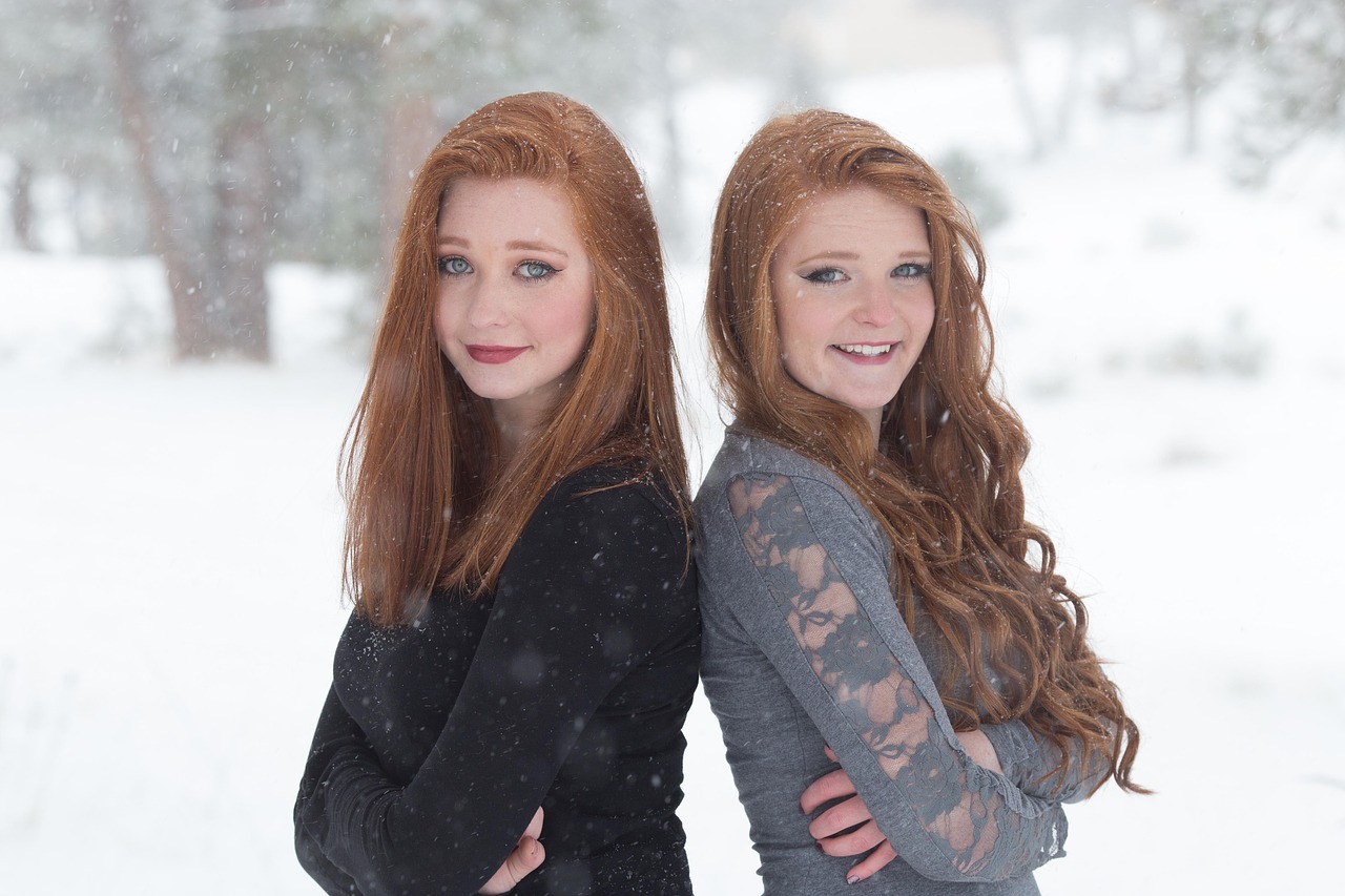 Two sisters posing for a photo together.
