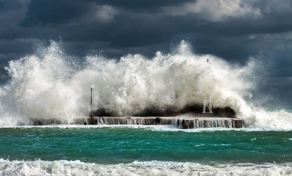 A frothy tidal wave crashing onto a platform.