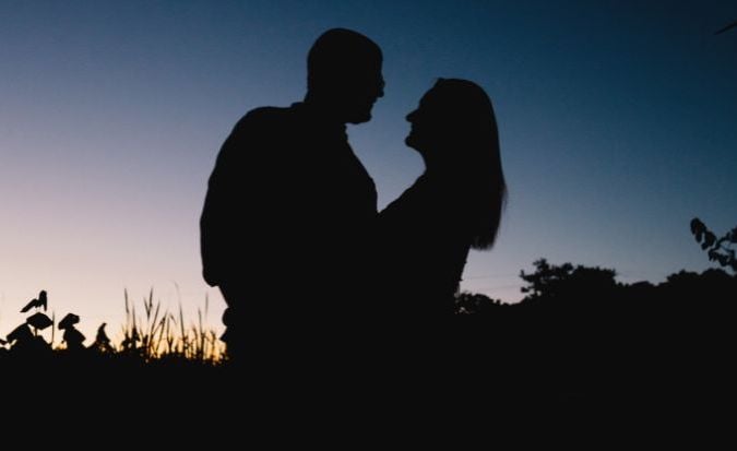A twin flame couple embracing at sunset.